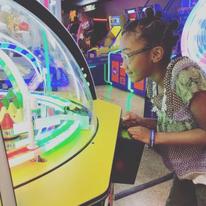 Young child playing new arcade games